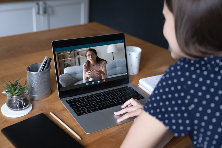 Stock photo of young woman at computer